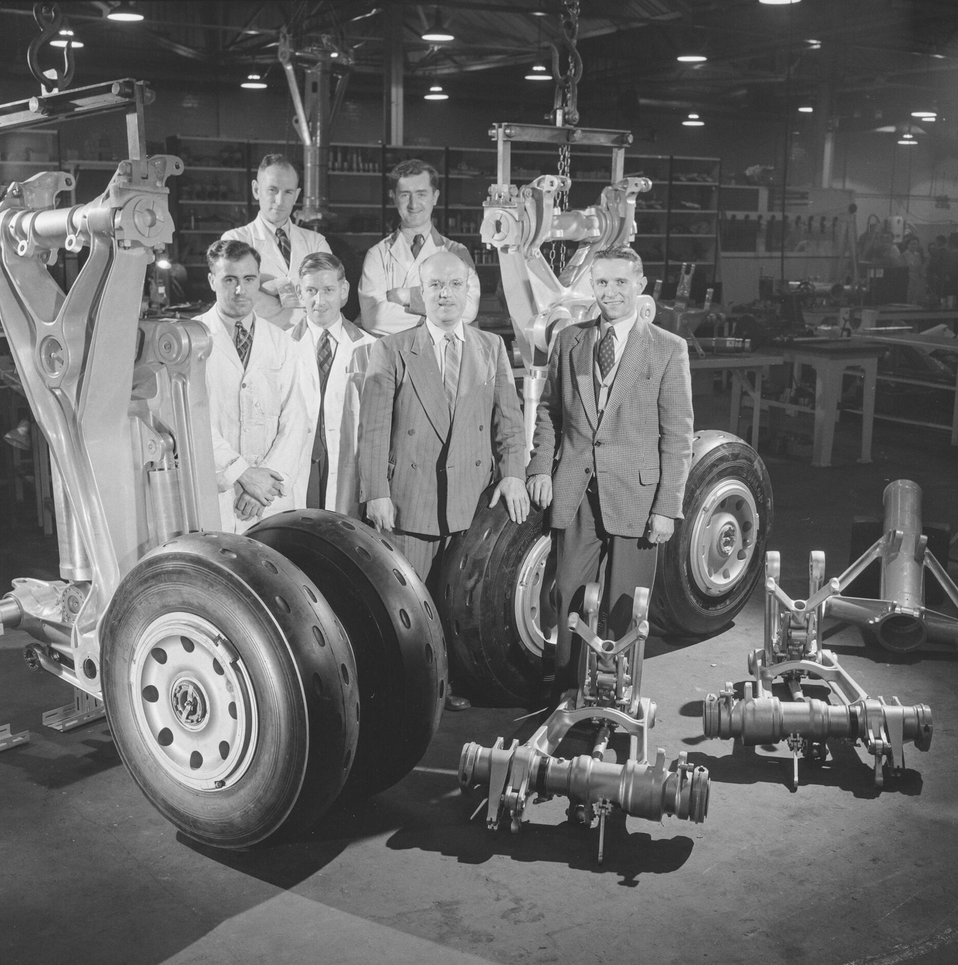 de Havilland Aircraft staff pose next to the first de Havilland DH.106 Comet 3 undercarriage produced at de Havilland Aircraft Lostock factory, 17th November 1953.